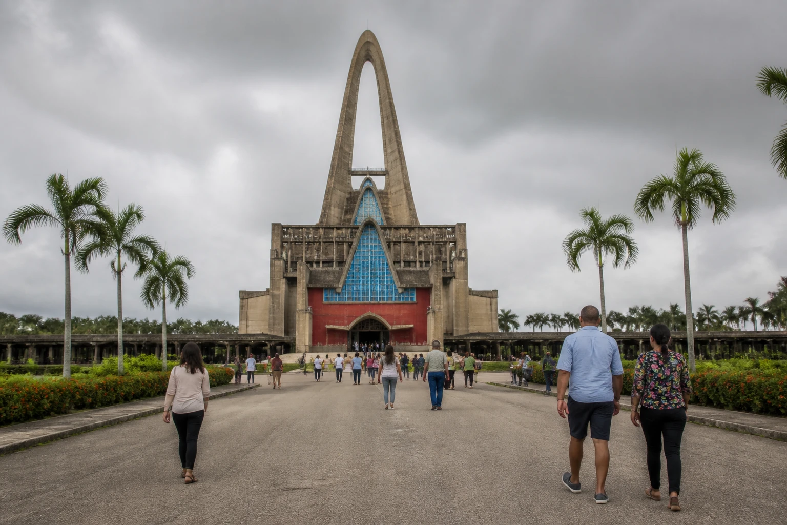 Visitors approaching the Higuey basilica under changing tropical weather.