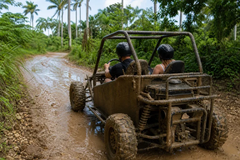 Unbranded side-by-side vehicle on a muddy tropical trail near Punta Cana