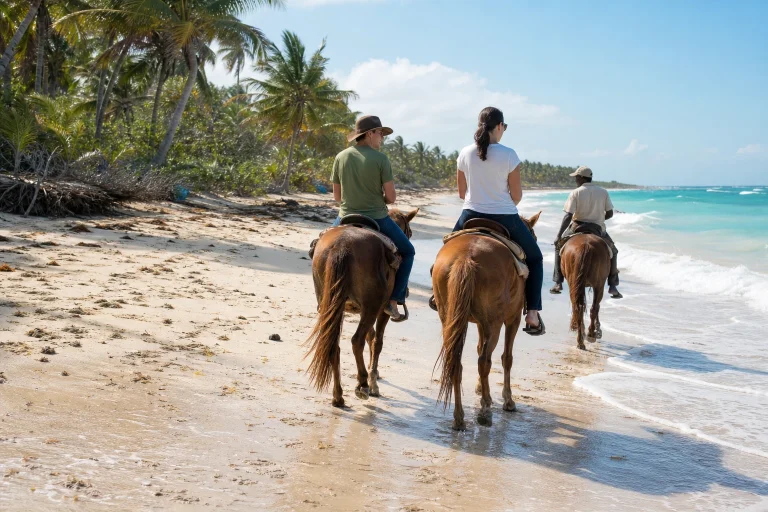 Travelers horseback riding with a guide on a Punta Cana beach