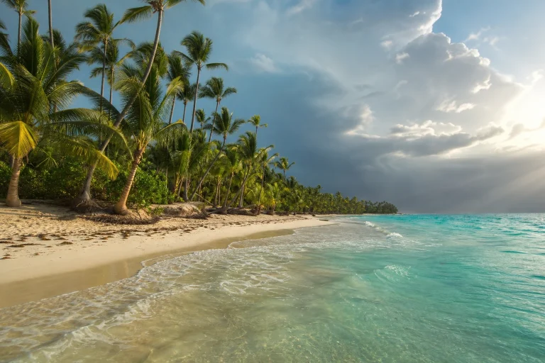 Punta Cana beach under mixed sun and summer clouds